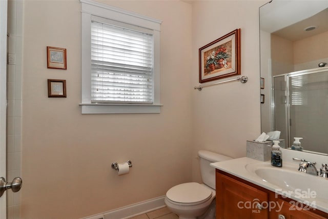 bathroom with vanity, an enclosed shower, tile patterned floors, and toilet