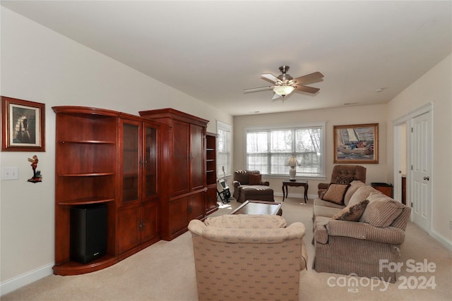 living room featuring light colored carpet and ceiling fan