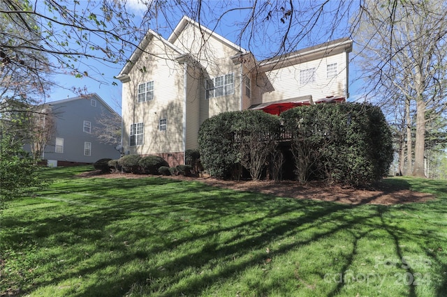 view of property exterior with a lawn