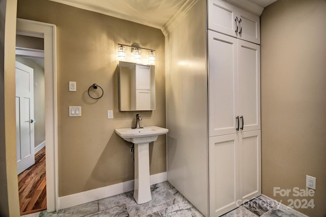 bathroom with crown molding and tile floors