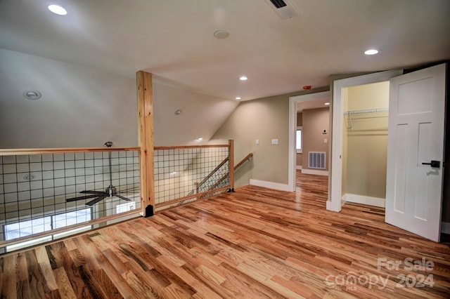 bonus room featuring hardwood / wood-style floors and vaulted ceiling