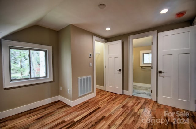 bonus room featuring hardwood / wood-style floors and vaulted ceiling