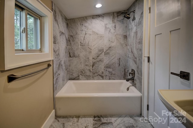 bathroom featuring tiled shower / bath combo and tile flooring