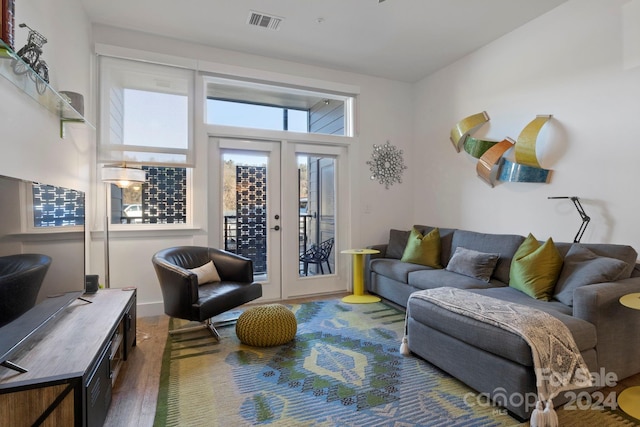 living room with french doors and dark wood-type flooring