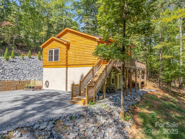 rear view of house with a wooden deck