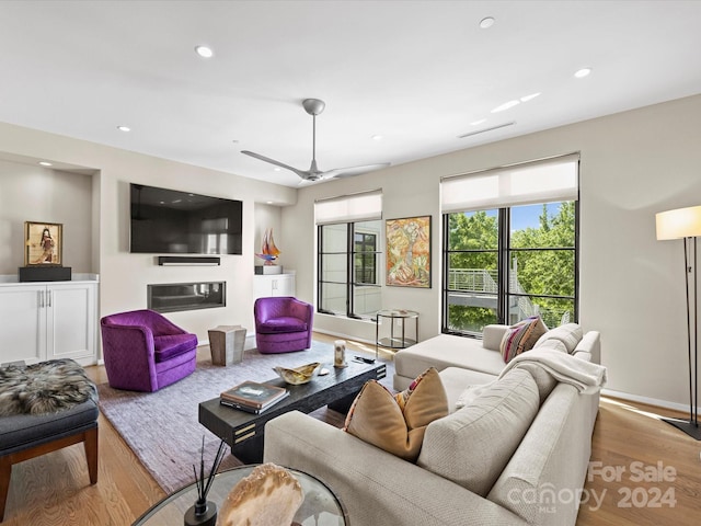 living room featuring ceiling fan and hardwood / wood-style floors