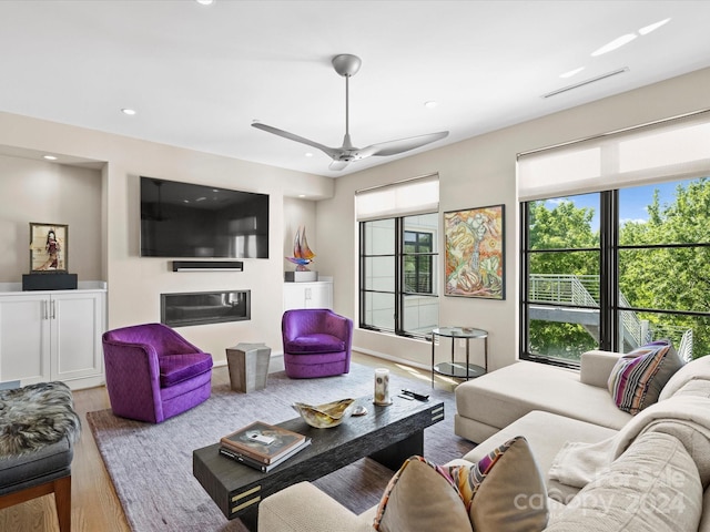 living room featuring wood-type flooring and ceiling fan