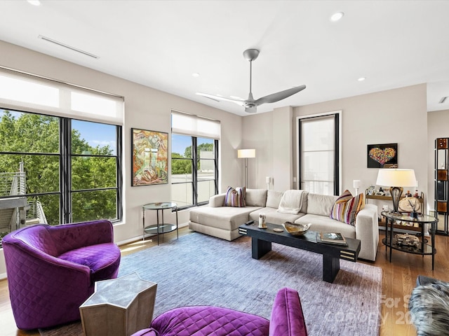 living room featuring hardwood / wood-style floors and ceiling fan