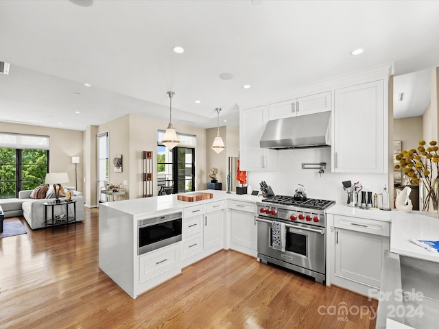 kitchen with light hardwood / wood-style flooring, designer stove, white cabinetry, and kitchen peninsula