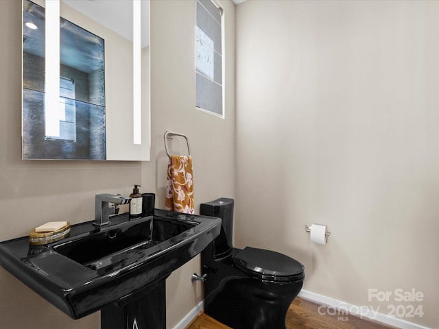 bathroom featuring hardwood / wood-style floors, sink, and toilet