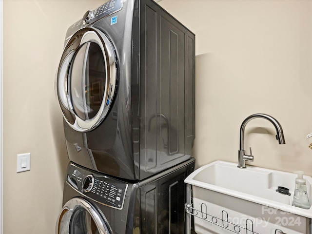 laundry area featuring sink and stacked washing maching and dryer