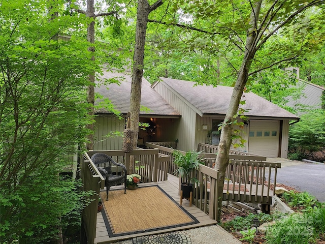 view of front of home with a wooden deck and a garage