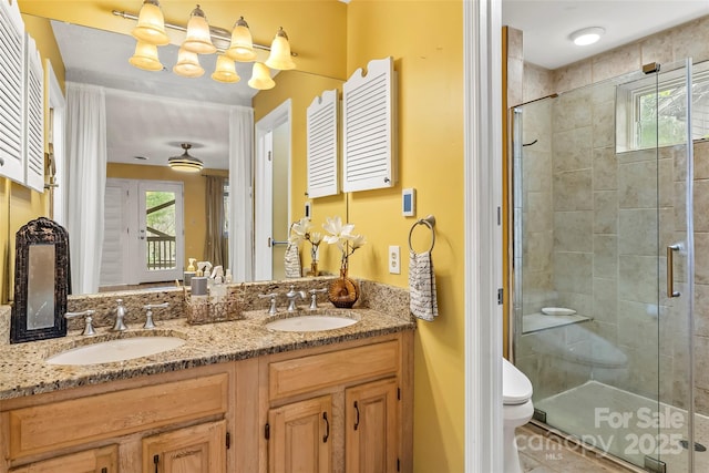 bathroom featuring walk in shower, vanity, and toilet