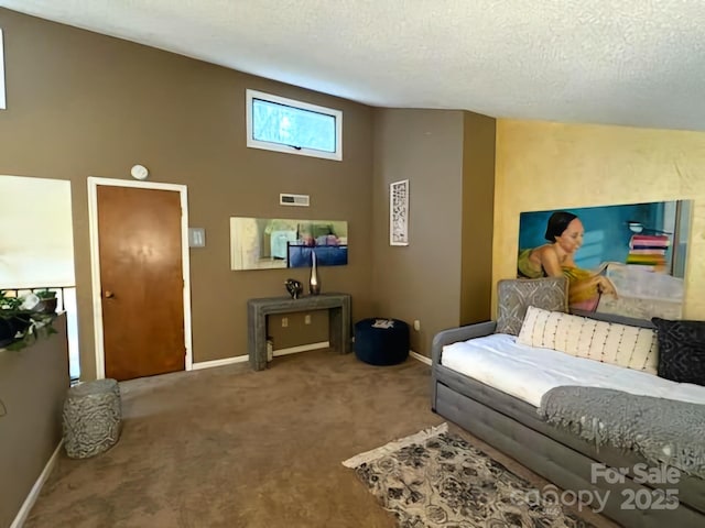 carpeted living room featuring vaulted ceiling and a textured ceiling