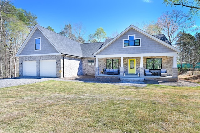 craftsman-style home with a front yard, a garage, and a porch