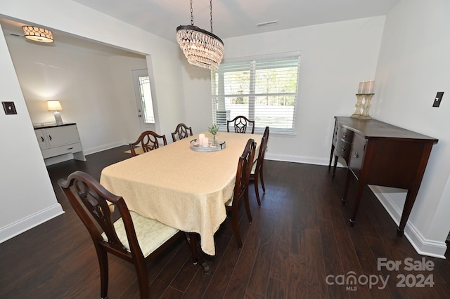 dining room featuring dark hardwood / wood-style floors and a notable chandelier