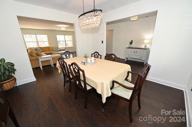 dining space with a chandelier and dark wood-type flooring