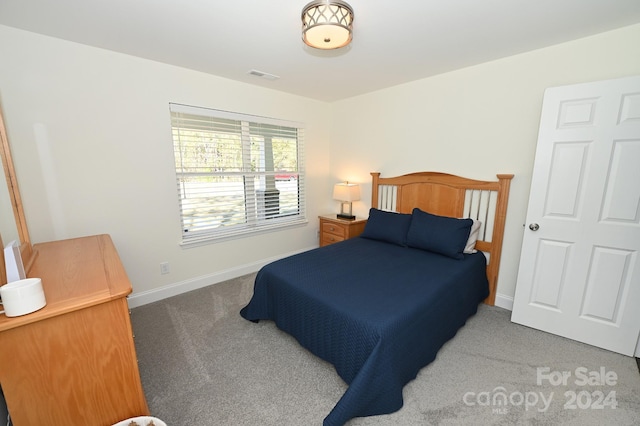 bedroom with dark colored carpet