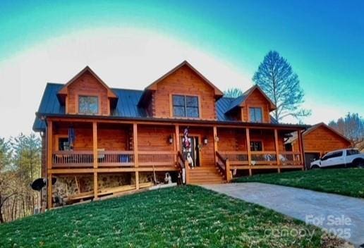 log-style house with a front lawn and covered porch