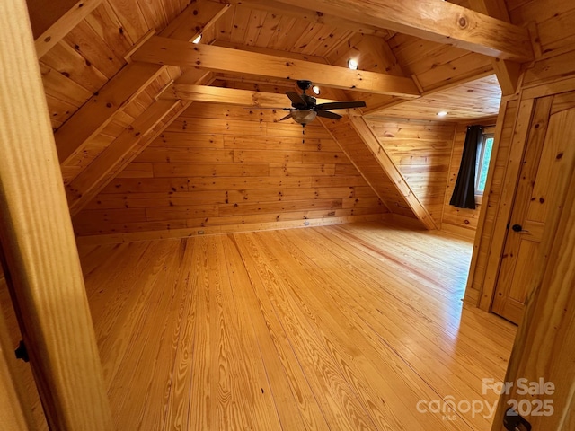 bonus room with beam ceiling, wooden walls, wood ceiling, and light hardwood / wood-style flooring