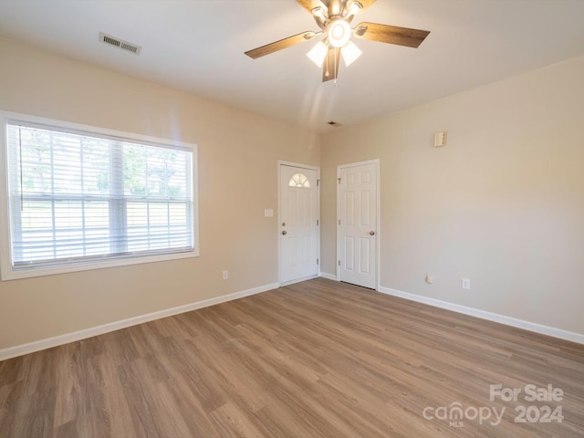 unfurnished room featuring ceiling fan and light hardwood / wood-style flooring