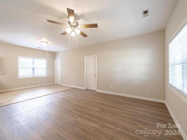 empty room featuring ceiling fan and hardwood / wood-style flooring