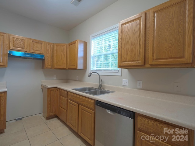 kitchen with dishwasher, sink, and light tile patterned flooring