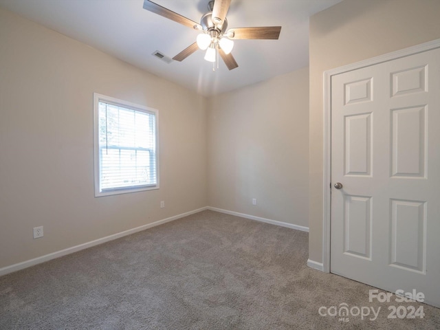 carpeted empty room with ceiling fan