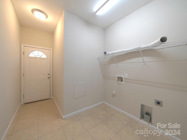 laundry room with hookup for an electric dryer, hookup for a washing machine, light tile patterned flooring, and gas dryer hookup