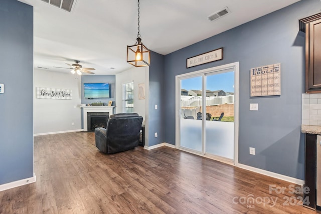 sitting room featuring dark wood-type flooring, wine cooler, and ceiling fan