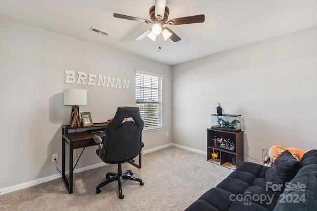 carpeted office featuring ceiling fan