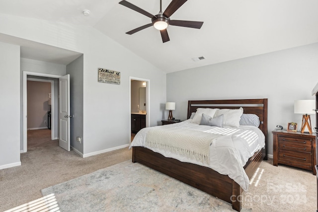 bedroom featuring light carpet, ensuite bath, ceiling fan, and vaulted ceiling