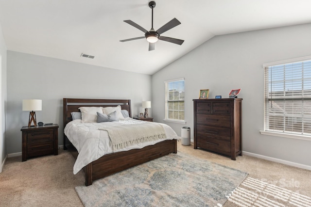 carpeted bedroom with vaulted ceiling and ceiling fan