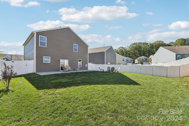 back of property featuring a lawn and a patio area