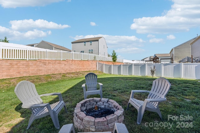 view of yard with a fire pit