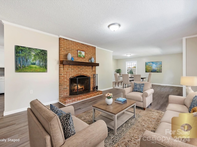 living room featuring crown molding, wood-type flooring, and a brick fireplace