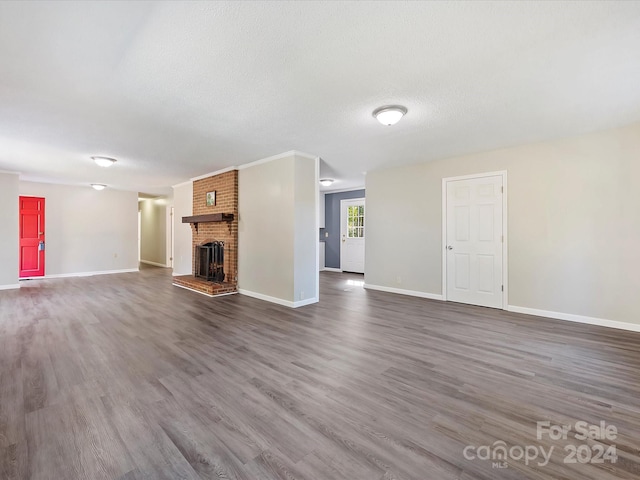 unfurnished living room with a textured ceiling, a fireplace, and dark hardwood / wood-style floors