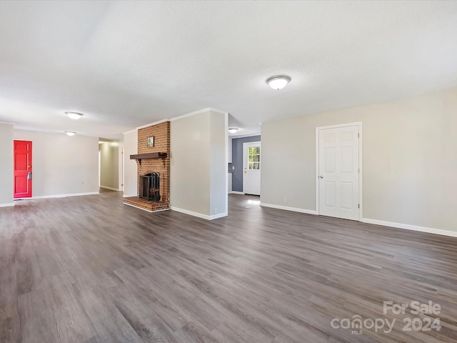 111 Bobby Lee Ln Unit 18, Mooresville, NC 28115 - unfurnished living room with dark wood finished floors, a fireplace, baseboards, and a textured ceiling