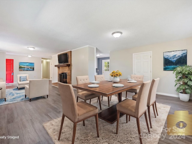 111 Bobby Lee Ln Unit 18, Mooresville, NC 28115 - dining space with wood finished floors, a brick fireplace, baseboards, and a textured ceiling