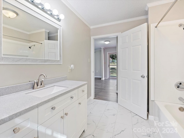 bathroom featuring wood-type flooring, shower / bathing tub combination, ornamental molding, vanity, and a textured ceiling