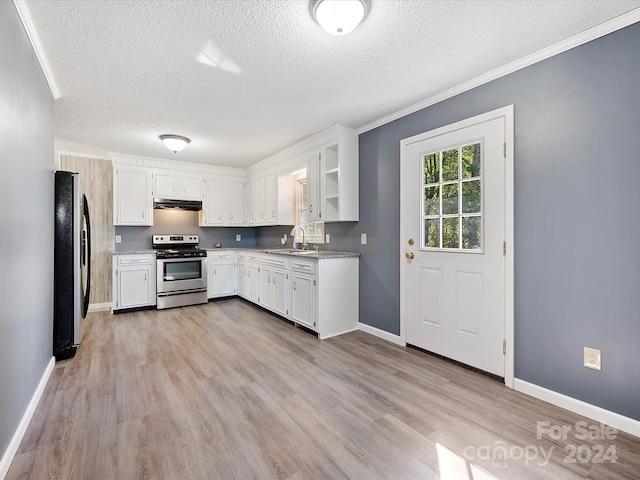 kitchen with stainless steel appliances, a textured ceiling, light wood-type flooring, and white cabinets