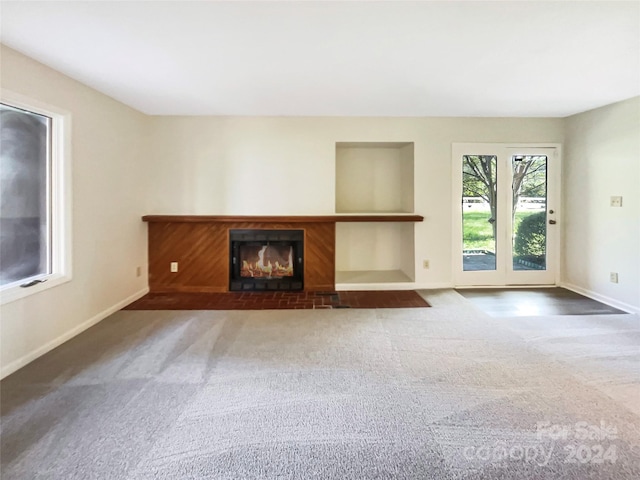 unfurnished living room with dark carpet