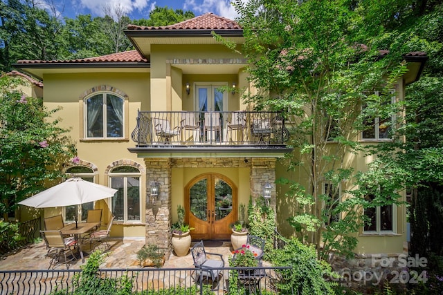 rear view of property with a balcony