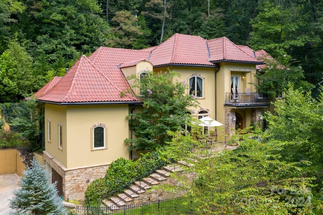 mediterranean / spanish-style home with a balcony