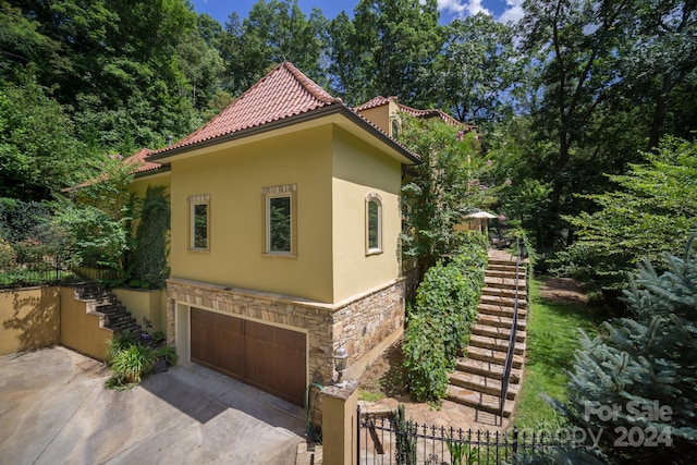 view of side of property featuring a garage