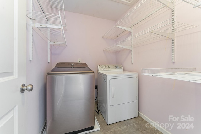 clothes washing area with separate washer and dryer