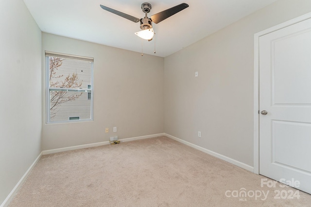 empty room with light carpet and ceiling fan