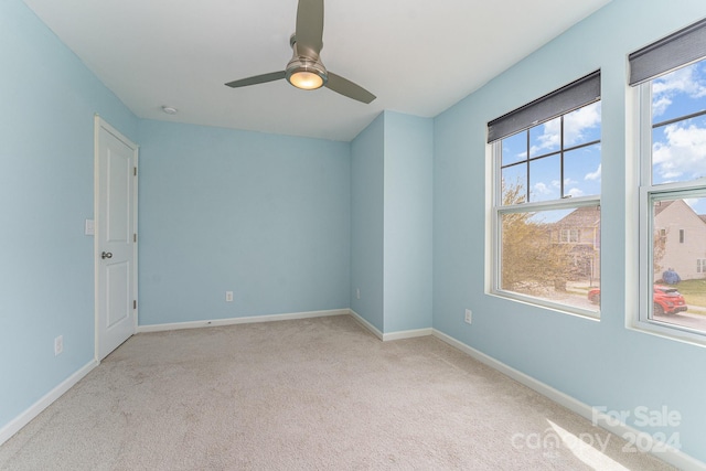 unfurnished room with ceiling fan and light colored carpet