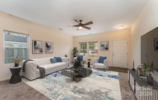 carpeted living room featuring ceiling fan