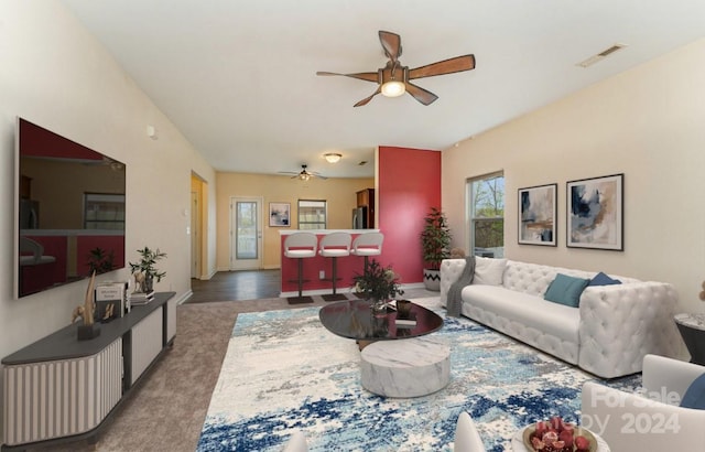 carpeted living room featuring ceiling fan